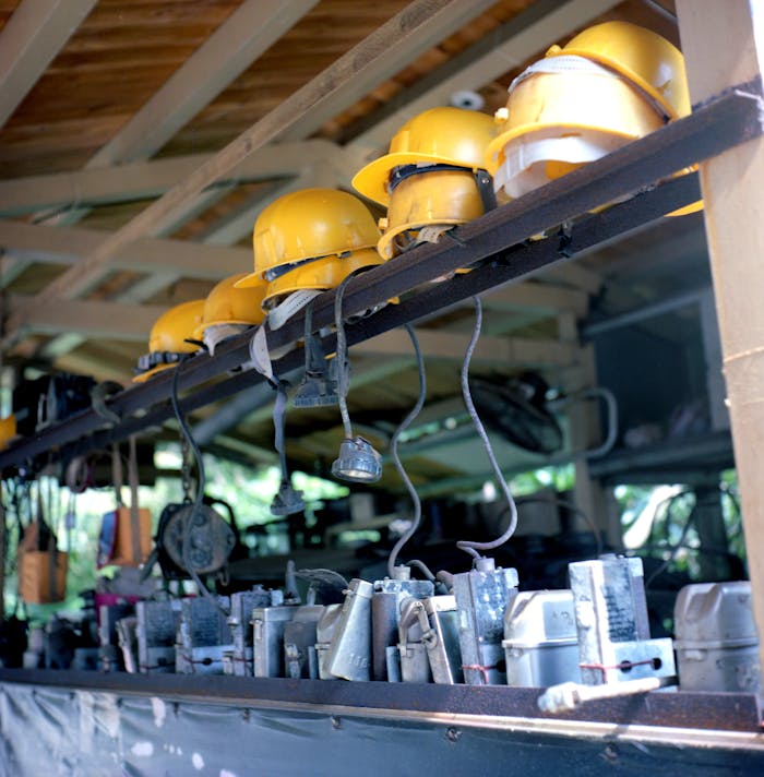 Yellow safety helmets lined on a shelf in an industrial setting in Taipei, Taiwan.